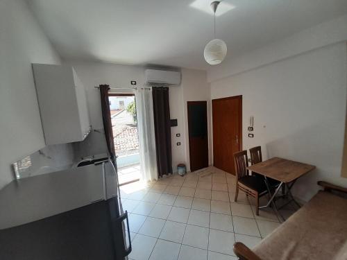 a kitchen and dining room with a table and a refrigerator at Aleksi&Eli in Shkodër