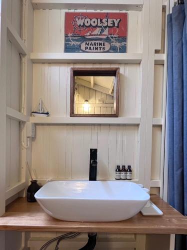a bathroom with a large white sink on a wooden table at MY LODGE Naoshima in Naoshima