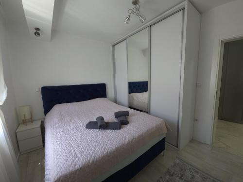 a bedroom with a bed with a mirror on it at Domatio Apartments in Novi Pazar