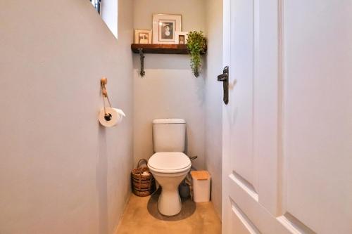 a bathroom with a toilet in a small room at The Castle in McGregor