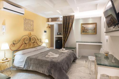 a bedroom with a large bed and a table at Federico 70 Giada Economy in Palermo