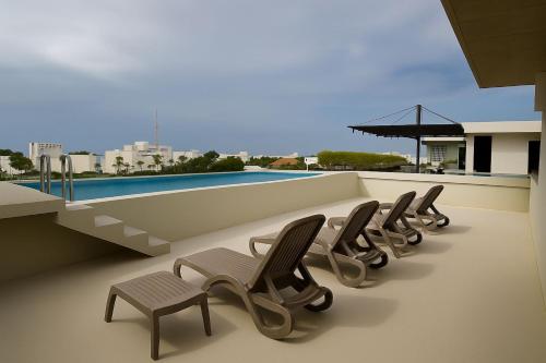 a row of chairs sitting on top of a building at MK Condo & Residences in Playa del Carmen