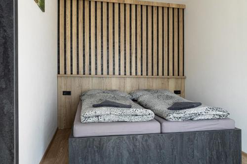 a bed with two pillows on top of it at San Marco - Na Brněnské ulici in Mutěnice