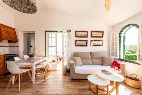 a living room with a couch and a table at Apartamentos Las Brisas I & II in Cala'n Bosch