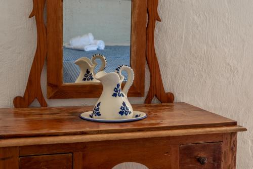 a vase sitting on a table in front of a mirror at Apartamentos Las Brisas I & II in Cala'n Bosch