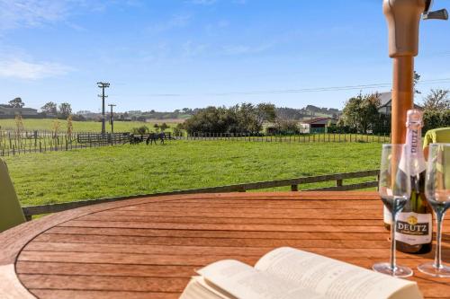 a table with two glasses and a bottle of wine at Country Comfort - only 10 minutes from Hamilton CBD in Hamilton