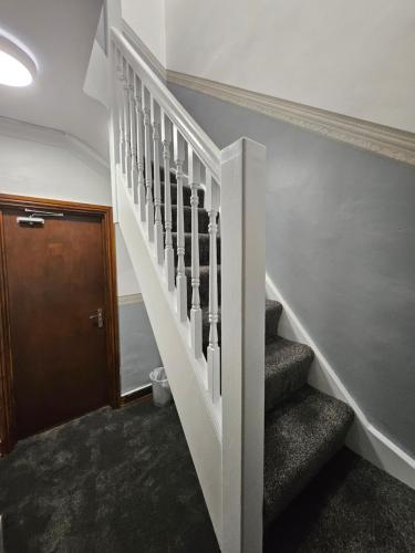 a staircase in a house with a stair case at SnoozeDen Wellesley - Near to Slough Station in Slough