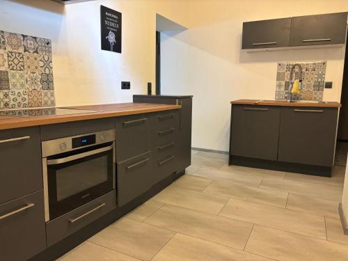 a kitchen with gray cabinets and a counter top at Altstadt Quartier in Hallenberg