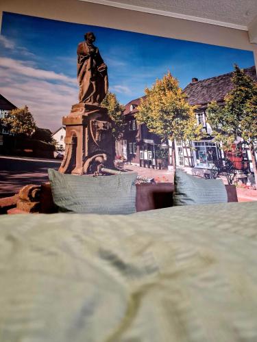 a statue of a man sitting on top of a monument at Altstadt Quartier in Hallenberg