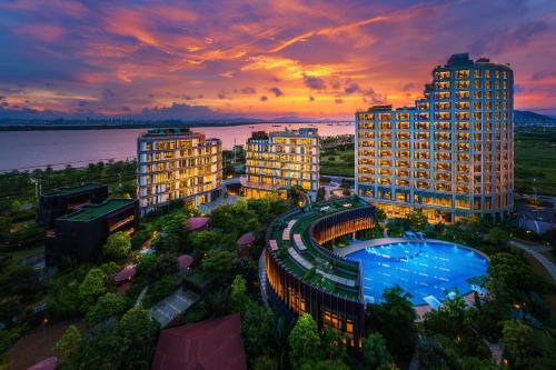 an aerial view of a resort with a pool and buildings at Serensia Woods Wellness Resort in Zhuhai