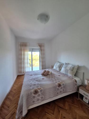 a bedroom with a large bed with flowers on it at Apartment Marina in Malinska