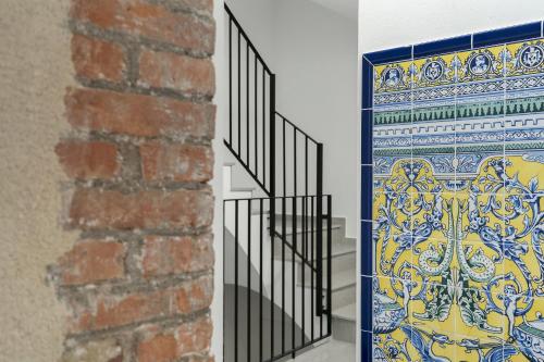 a staircase with a wrought iron railing next to a brick wall at Casa Castell Orangecosta in Peñíscola