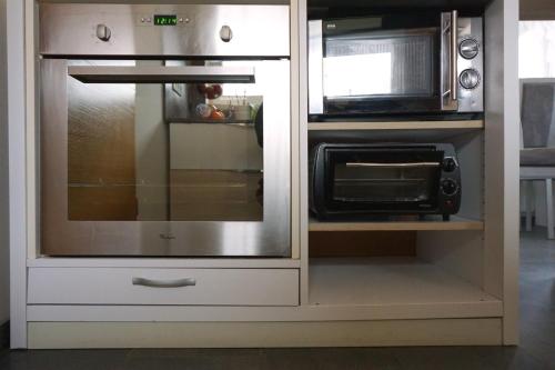 a microwave and a toaster oven in a kitchen at Holiday home in a top location in Ferlach