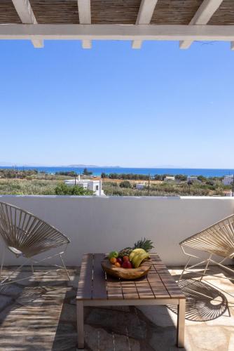 a bowl of fruit on a table on a patio at Anthea Hotel in Tinos Town