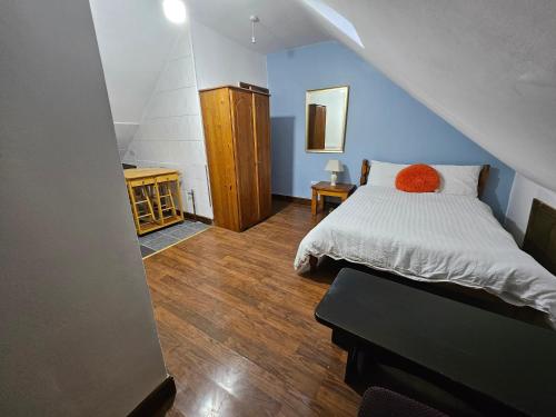 a bedroom with a white bed and blue walls at SnoozeDen Wellesley - Near to Slough Station in Slough