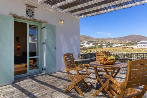 a table and chairs on a patio with a view at Anthea Hotel in Tinos Town