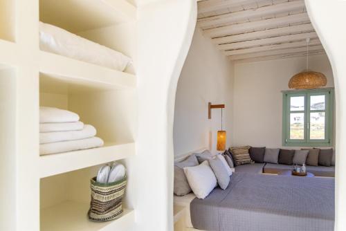 a living room with a couch and a bed at Anthea Hotel in Tinos Town