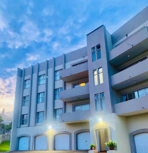 a large white building with windows and doors at Costa Smeralda in Margate