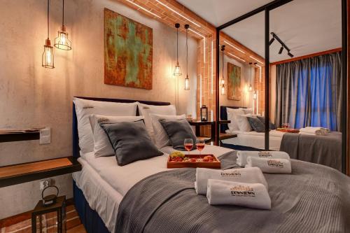 a bedroom with two beds with glasses of wine at Żurawie - Food Hall, Parking & Stocznia by Downtown Apartments in Gdańsk