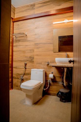 a bathroom with a toilet and a sink at Casa Aqua Mandrem in Mandrem