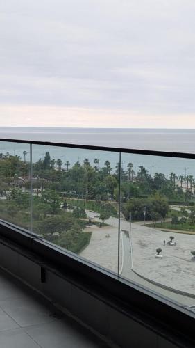 a view of a beach from a window of a building at Gizo apartments in Batumi