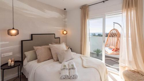 a bedroom with a bed with two slippers on it at Apartamento Balcón El Rincón by Ruralidays in Rincón de la Victoria