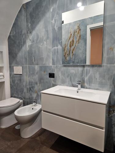 a bathroom with a sink and a toilet at Be Your Home - Guest House Montegrappa Terrace in Civitavecchia