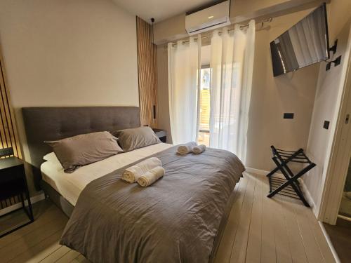 a bedroom with a bed with two stuffed animals on it at Be Your Home - Guest House Montegrappa Terrace in Civitavecchia