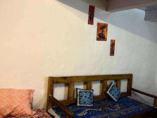 a room with a wooden bed with pillows on it at The velox Traditional Home Stay in Kalpa