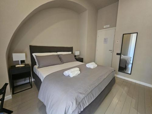 a bedroom with a bed with two towels on it at Be Your Home - Guest House Montegrappa Terrace in Civitavecchia