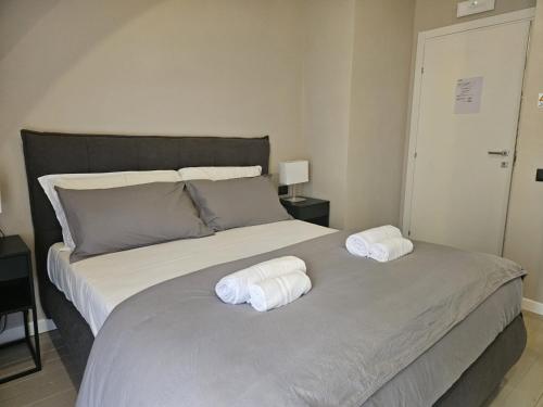 a bedroom with a bed with towels on it at Be Your Home - Guest House Montegrappa Terrace in Civitavecchia