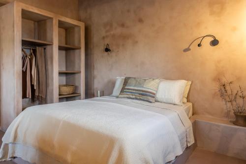 a bedroom with a white bed in a room at Terracotta Fiscardo Villas in Fiskardho