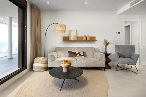 a living room with a couch and a table at Luxury 3bed-Apartment with Stunning Sea Views in Rincón de la Victoria