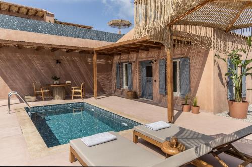 a villa with a swimming pool and a patio at Terracotta Fiscardo Villas in Fiskardho