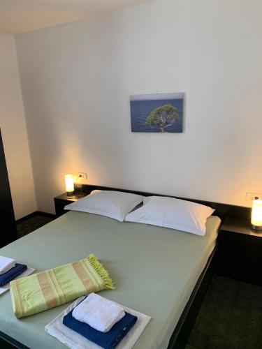 a bedroom with a bed with two towels on it at Guest House Alek in Vrboska