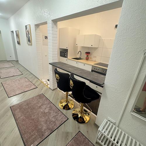 a kitchen with a counter and two bar stools at Ferienwohnung in Göppingen