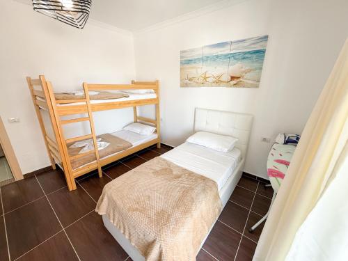 a small room with a bed and a bunk bed at Velipoje Fishta Apartment Q6 33 in Velipojë