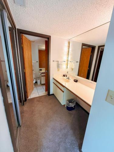 a bathroom with a sink and a mirror at Lakeview Treetop Village77-3Bed3BAPools-8PP in Four Seasons