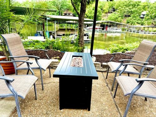 a table with two chairs and a table with a fire place at Treetop Village-3bed3bathpoolsdockpickleball in Four Seasons