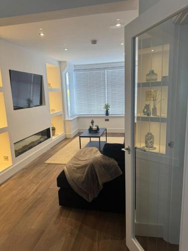 a living room with a couch and a table at Rhos On Sea Getaway in Rhôs-on-Sea
