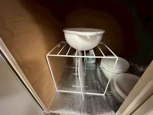 a white bowl sitting on a shelf in a drawer at カサデューク平岸45 in Toyohira