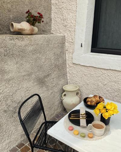 a table and chair with a plate of food on it at Villetta Moscal - Buon Gusto in Affi