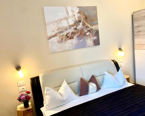 a bedroom with a bed with pillows on it at Villetta Moscal - Buon Gusto in Affi