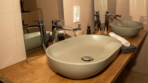 a bathroom with a white sink and a mirror at Feilchenhof in Freilassing