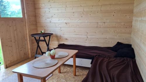a small room with a bed and two tables at Salomon Glamping in Mooste