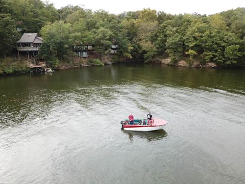 a couple of people in a boat on a river at Treetop Village100-3bed3bathindoor Pool8pp in Four Seasons