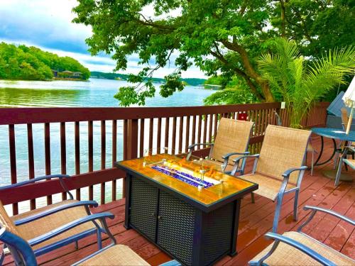 a table and chairs on a deck with a view of the water at Treetop Village100-3bed3bathindoor Pool8pp in Four Seasons