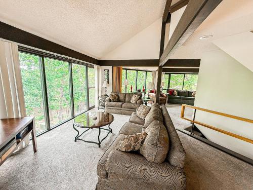 a living room with a couch and a table at Treetop Village100-3bed3bathindoor Pool8pp in Four Seasons