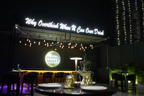 a table with chairs and a sign that says why consultants when i can one drink at Hotel Rishabh in Jhānsi