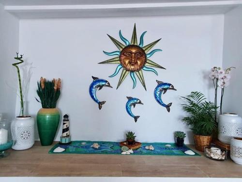 a mural of the sun with fish on a wall at Finca Maradentro - private pool and jacuzzi with ocean view in Arafo